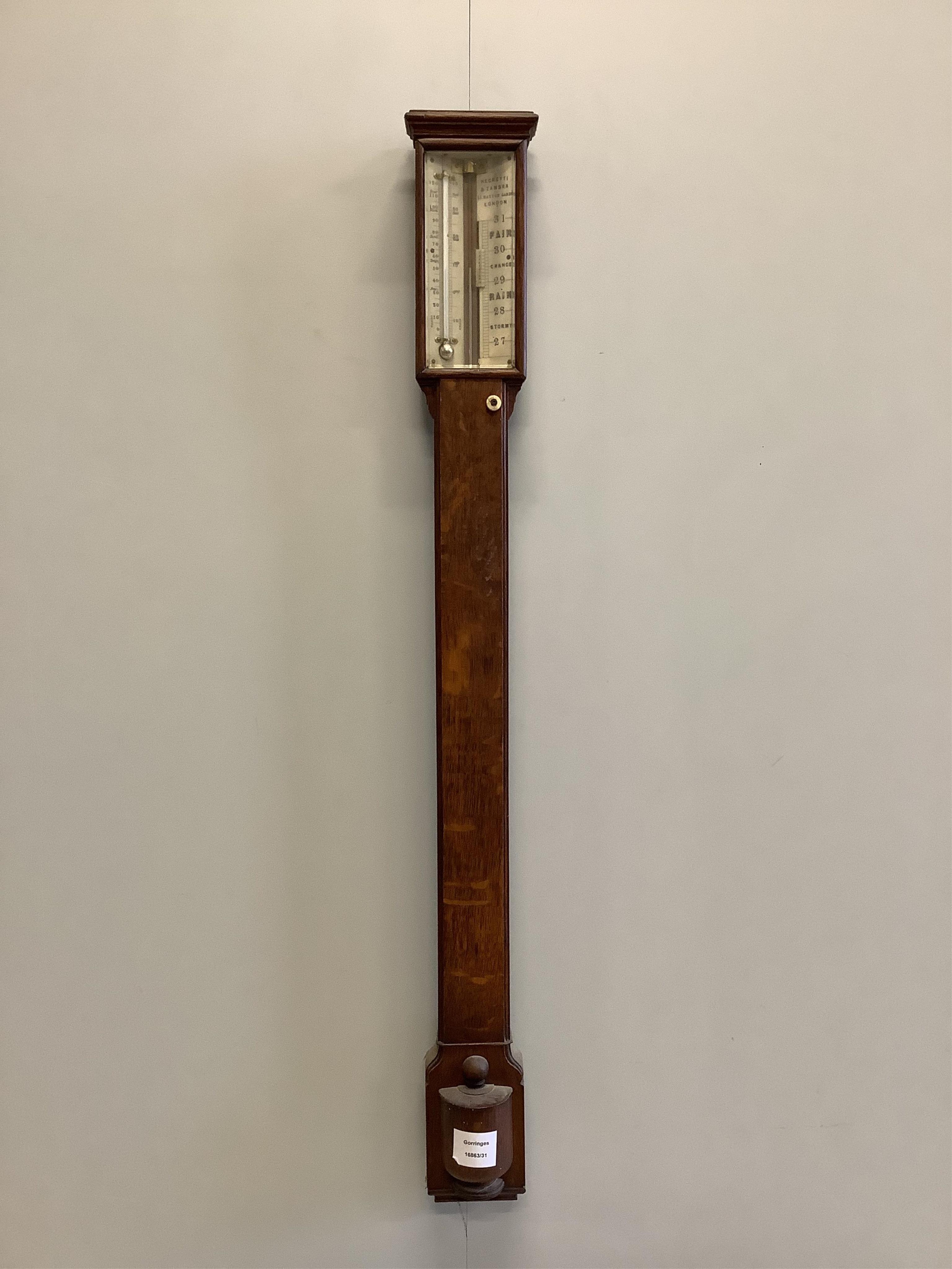 A Victorian Negretti and Zambra oak stick barometer and thermometer, with engraved bone dial, height 97cm. Condition - fair